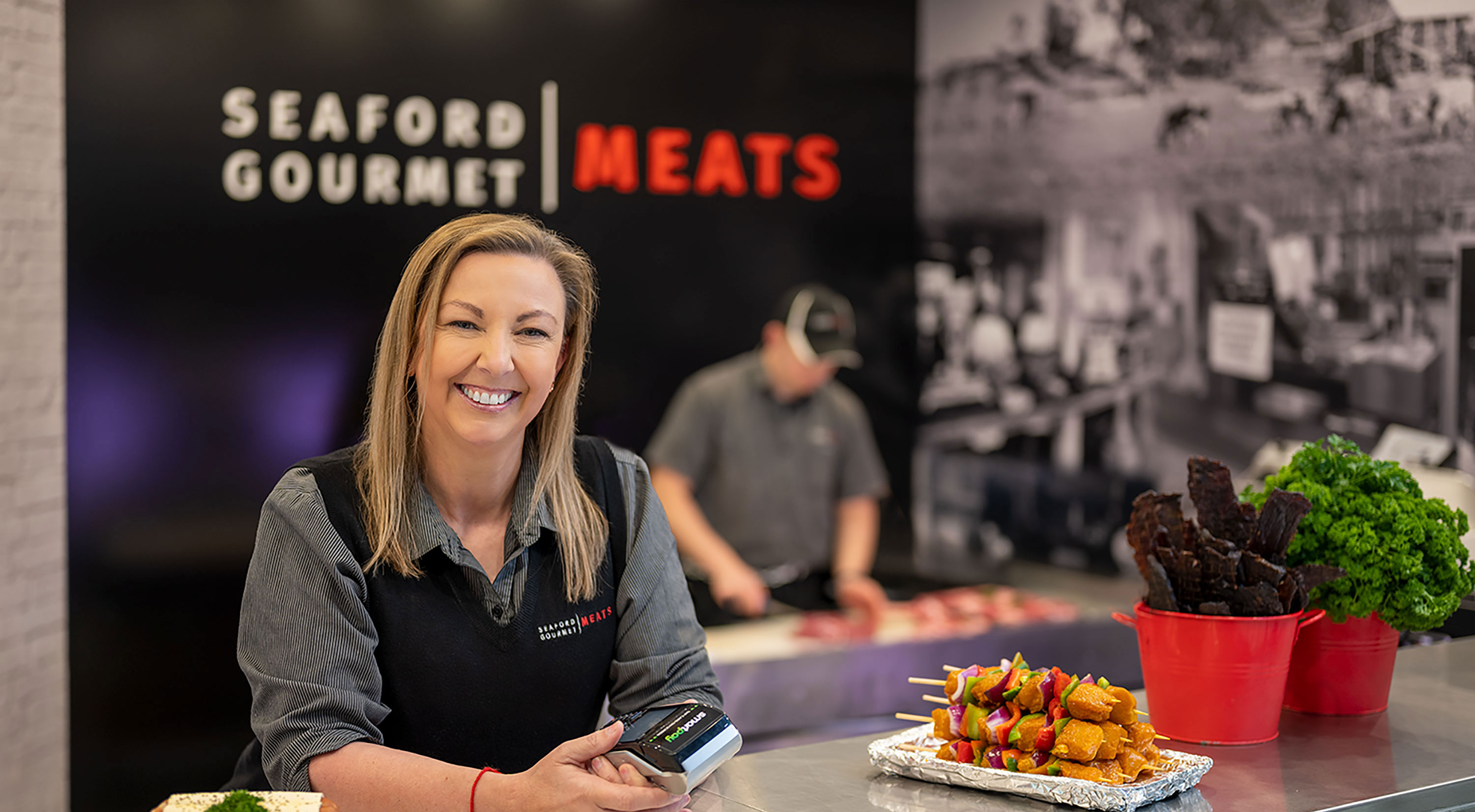 Woman from Seaford Gourmet Meats smiling at camera.